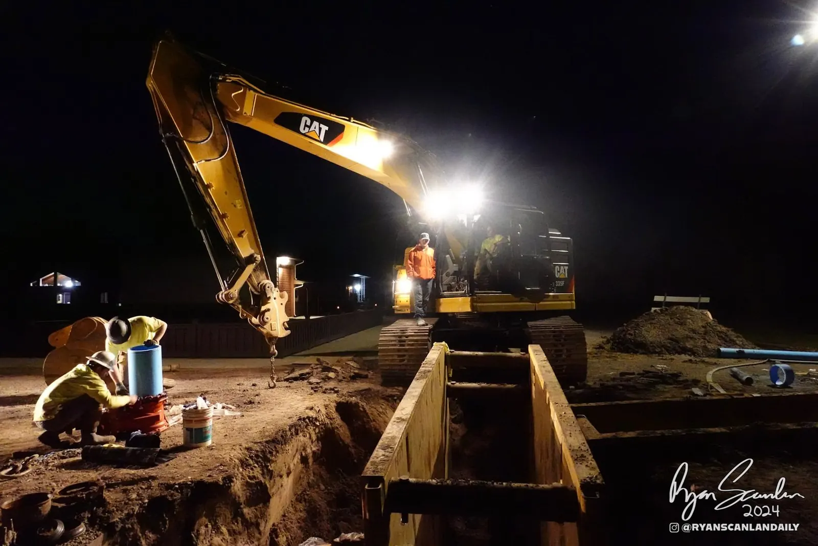 TaylorX crew performing night utility trench work with heavy equipment in Montana